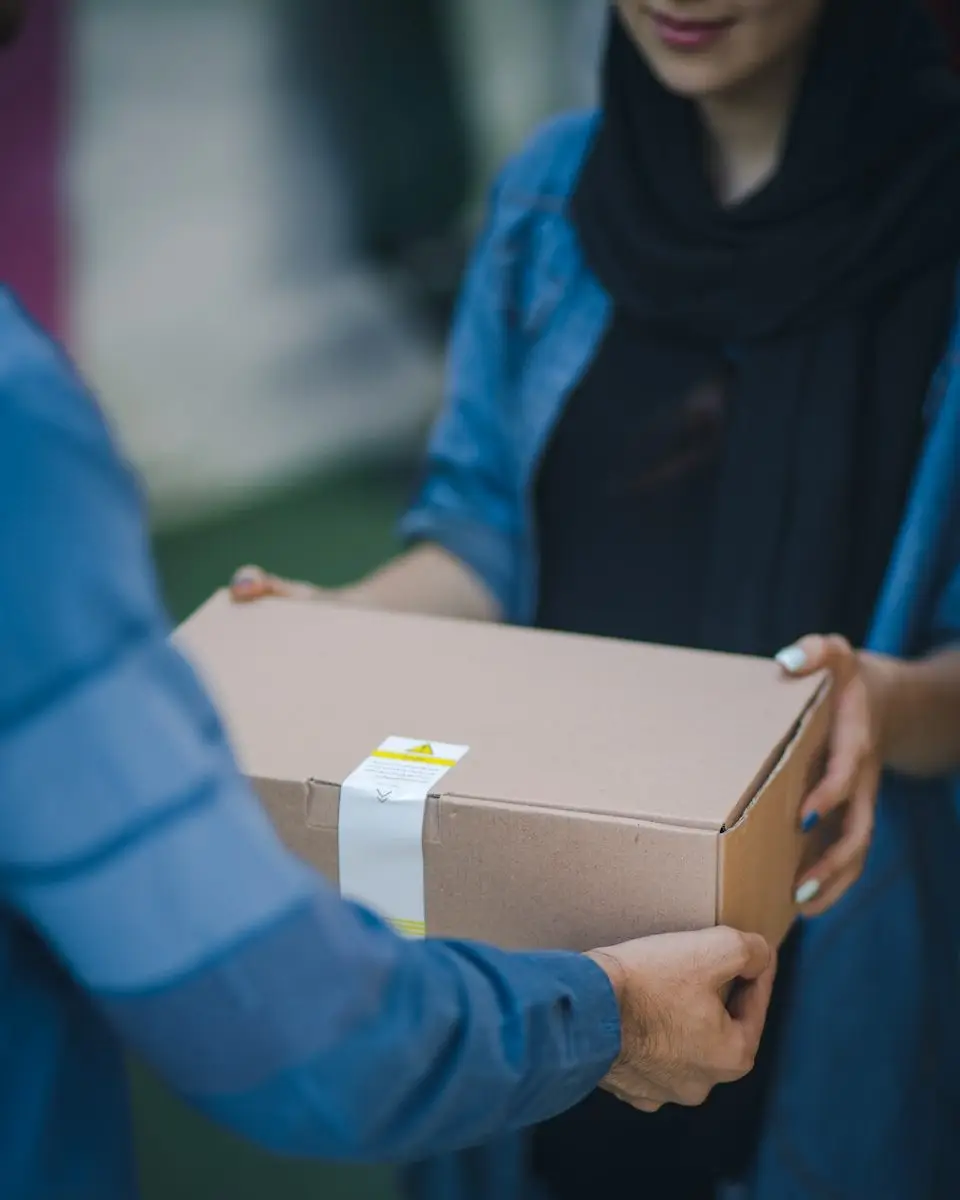 person giving brown box with medical supply delivery